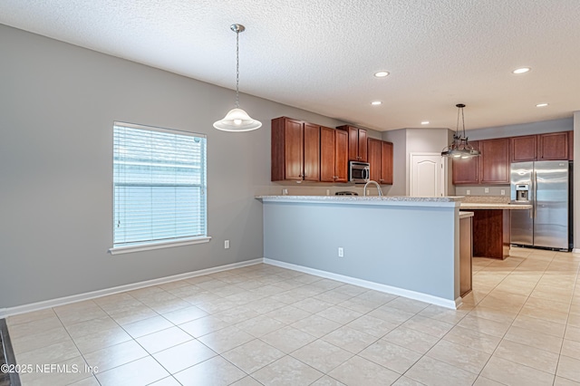 kitchen with hanging light fixtures, stainless steel appliances, and a textured ceiling