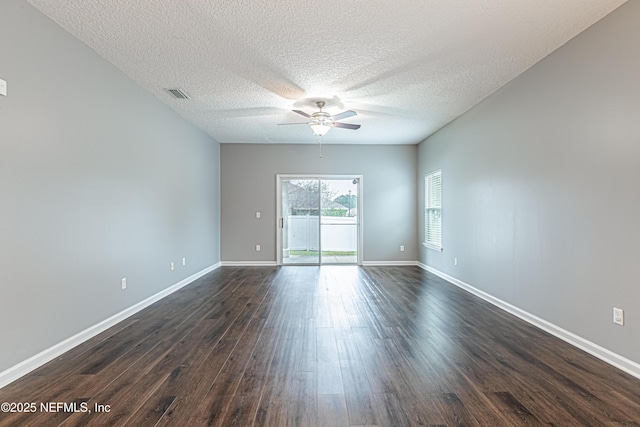 spare room featuring ceiling fan, dark hardwood / wood-style floors, and a textured ceiling