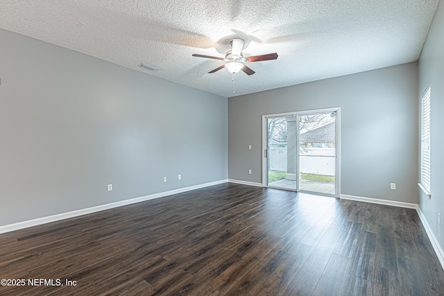 spare room with dark hardwood / wood-style flooring, a textured ceiling, and ceiling fan