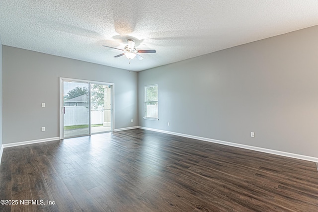 empty room with dark hardwood / wood-style floors, a textured ceiling, and ceiling fan