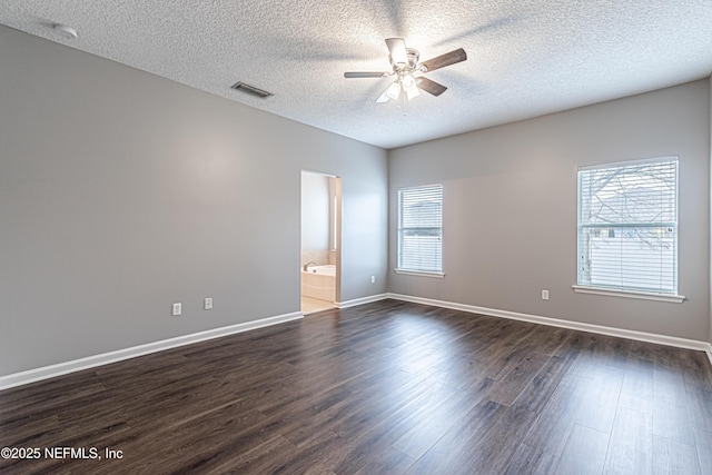 unfurnished room featuring ceiling fan, dark hardwood / wood-style flooring, and a textured ceiling