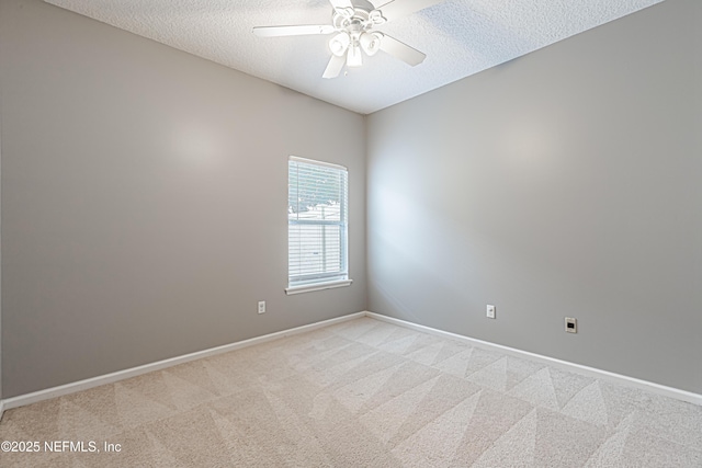 carpeted spare room with ceiling fan and a textured ceiling