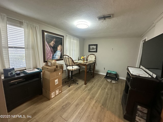 office featuring light hardwood / wood-style floors and a textured ceiling