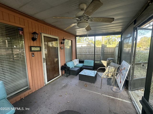 sunroom / solarium featuring ceiling fan