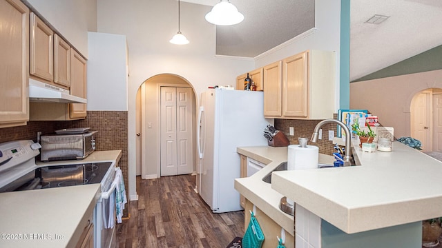 kitchen with white appliances, arched walkways, dark wood-style flooring, light countertops, and under cabinet range hood