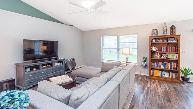 living area featuring vaulted ceiling, ceiling fan, wood finished floors, and baseboards