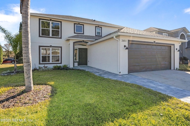 view of front of house with a garage and a front lawn