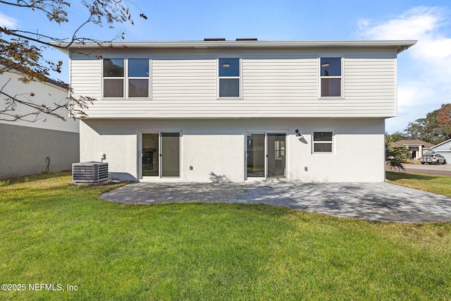 rear view of property featuring a patio, a yard, and cooling unit