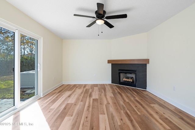 unfurnished living room with a fireplace, light hardwood / wood-style floors, and ceiling fan