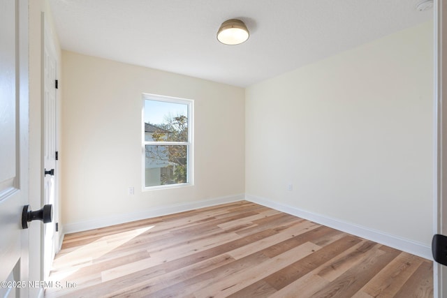 unfurnished room with light hardwood / wood-style flooring