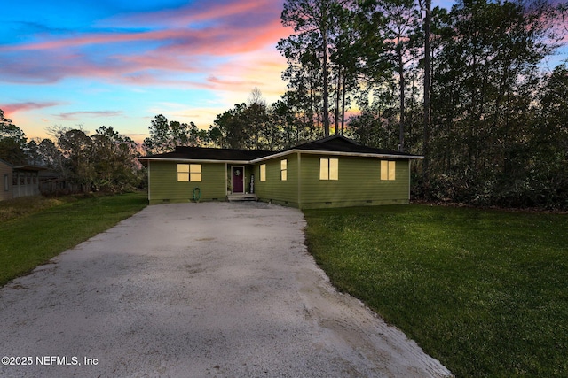 ranch-style home with a lawn