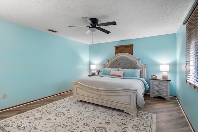 bedroom featuring ceiling fan, a textured ceiling, and light hardwood / wood-style flooring