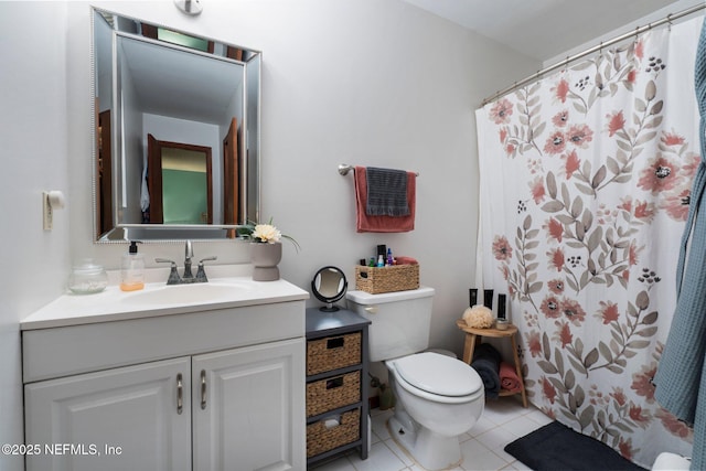 bathroom featuring vanity, a shower with shower curtain, tile patterned floors, and toilet