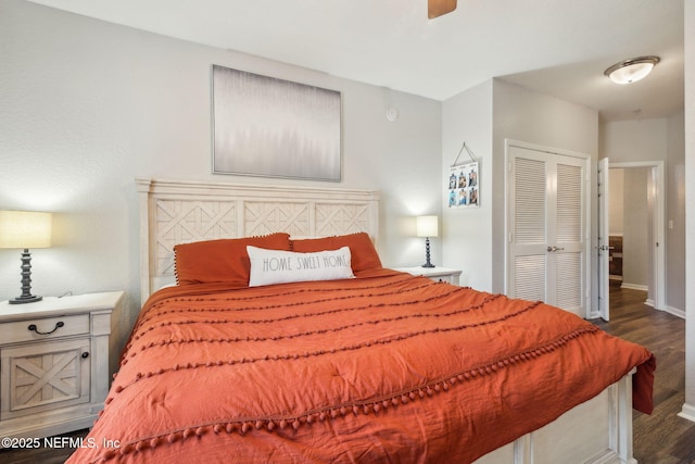 bedroom with ceiling fan, dark hardwood / wood-style flooring, and a closet