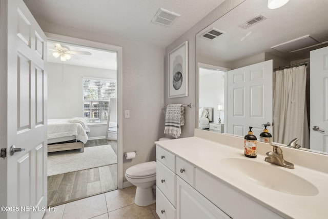 bathroom featuring vanity, ceiling fan, tile patterned floors, and toilet