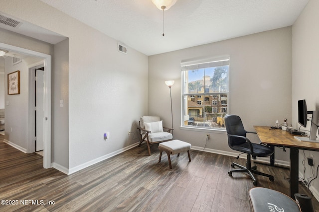 home office with dark hardwood / wood-style flooring