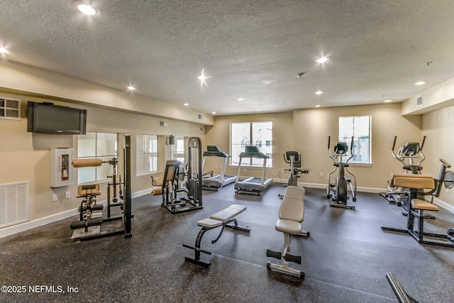 exercise room with a textured ceiling