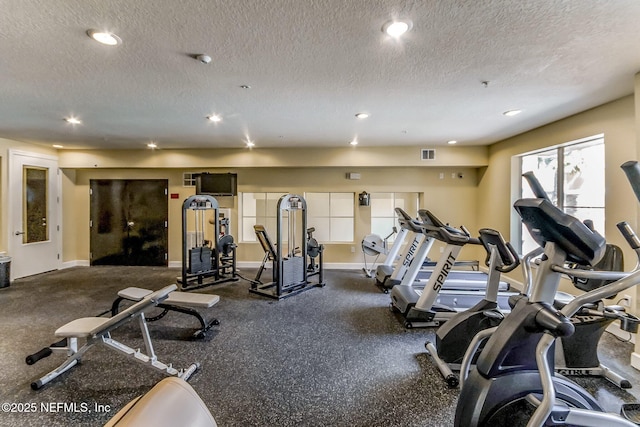 exercise room featuring a textured ceiling