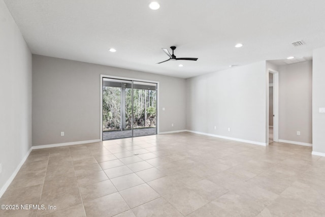 empty room with ceiling fan and light tile patterned floors