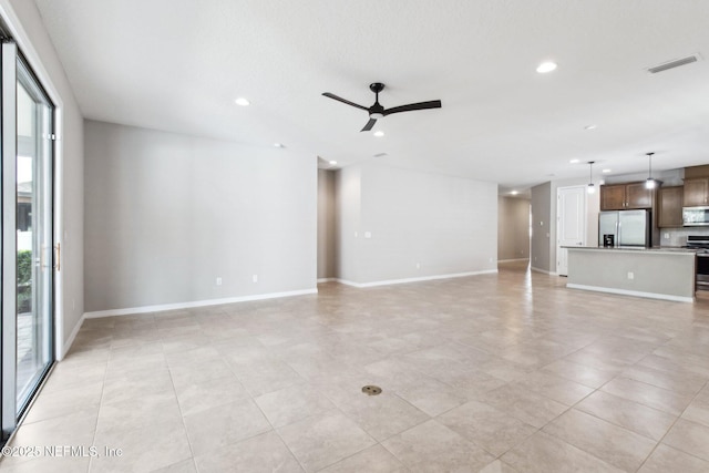 unfurnished living room featuring ceiling fan