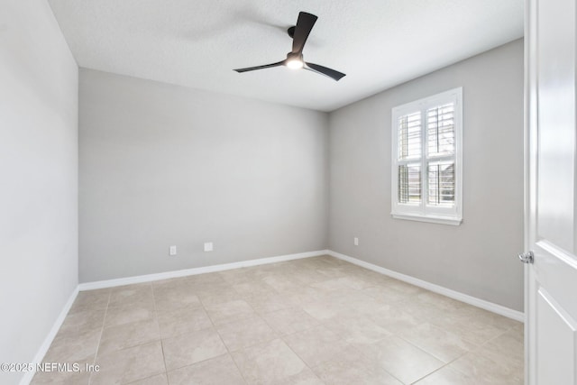 empty room with a textured ceiling and ceiling fan