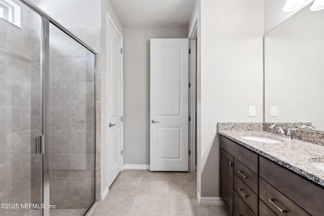 bathroom featuring tile patterned flooring, vanity, and walk in shower