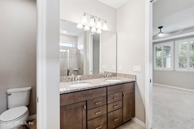 bathroom with vanity, toilet, and walk in shower