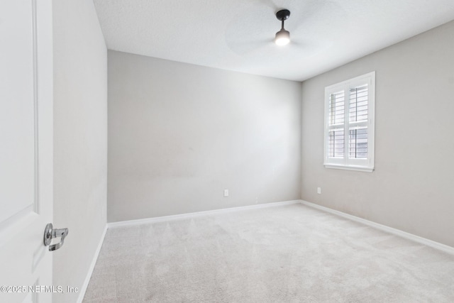 empty room featuring carpet flooring, a textured ceiling, and ceiling fan