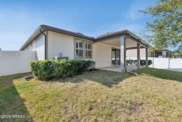 back of property featuring cooling unit, a lawn, and a patio