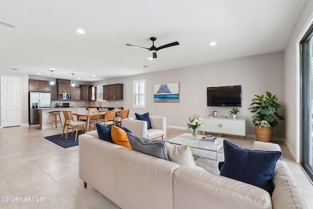 living room featuring light tile patterned floors and ceiling fan