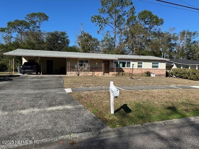 ranch-style house featuring a carport