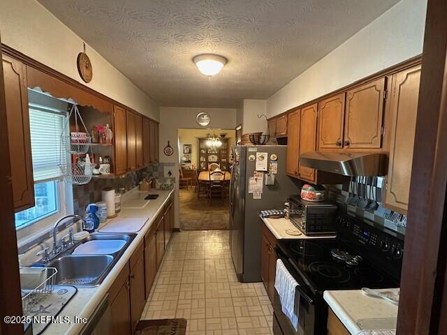 kitchen featuring sink, black range with electric cooktop, and a textured ceiling