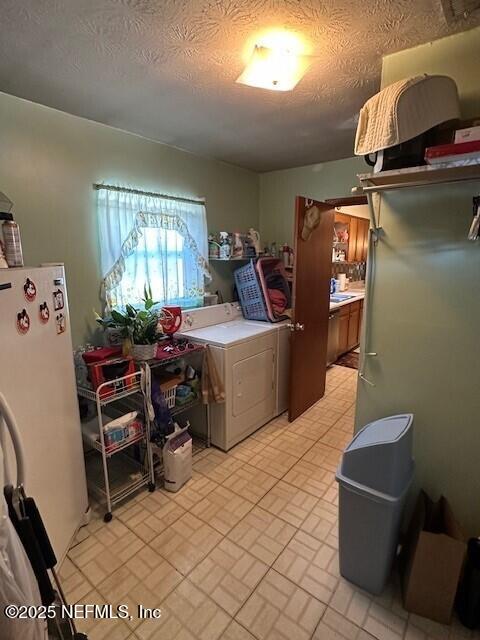 laundry area featuring washer / dryer and a textured ceiling