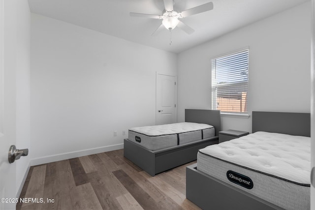 bedroom featuring dark wood-type flooring and ceiling fan