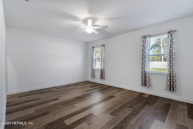 spare room with dark hardwood / wood-style floors and ceiling fan