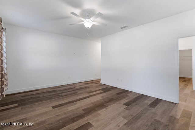 unfurnished room featuring dark hardwood / wood-style floors and ceiling fan