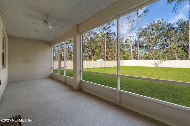 unfurnished sunroom featuring ceiling fan