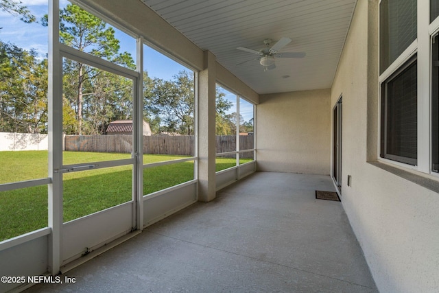 unfurnished sunroom with ceiling fan