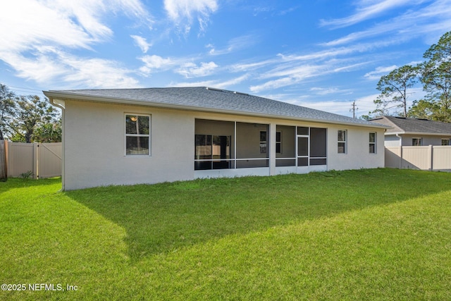 rear view of property with a yard