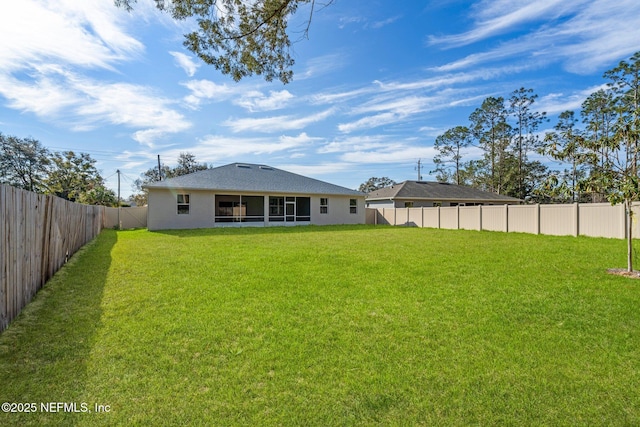 back of property with a lawn