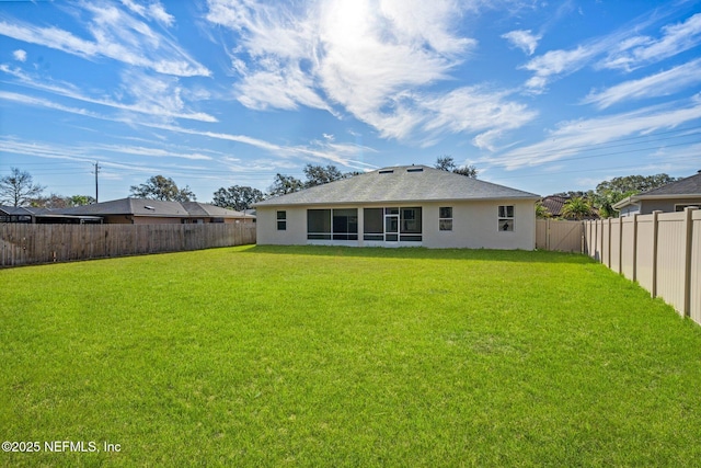 rear view of house with a yard