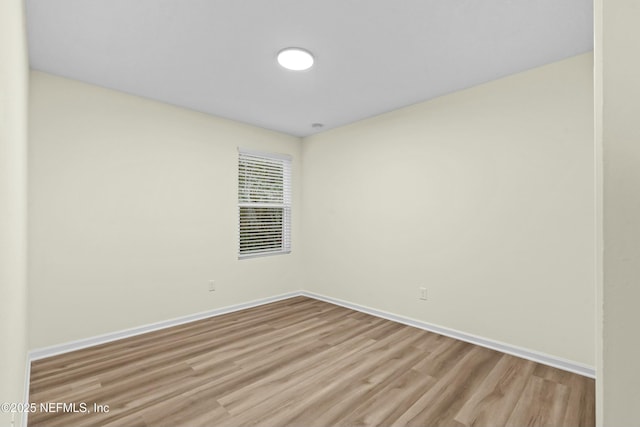unfurnished room with light wood-type flooring
