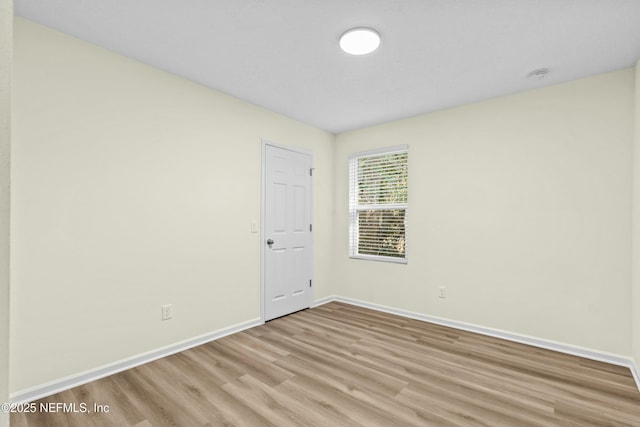 spare room with light hardwood / wood-style flooring