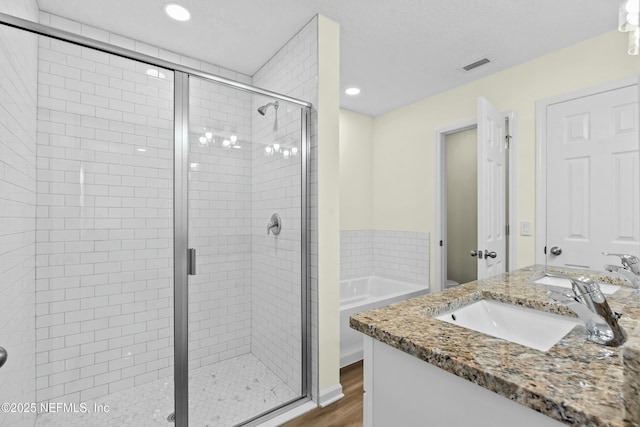 full bathroom with vanity, wood-type flooring, independent shower and bath, and toilet