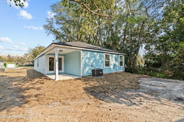 rear view of property featuring a patio and central air condition unit