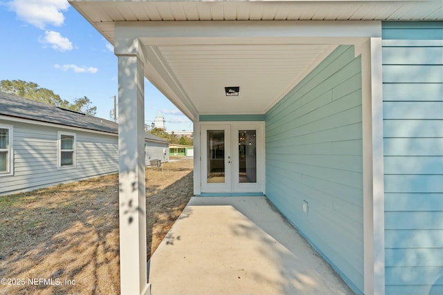 property entrance featuring a patio and french doors