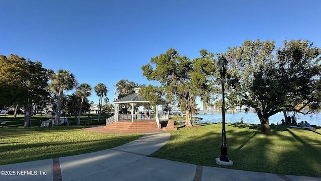 view of home's community featuring a gazebo, a water view, and a lawn