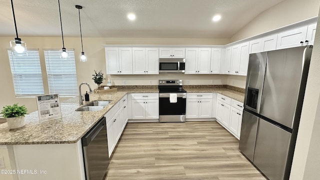 711 N Pine Ave, Green Cove Springs, FL 32043 - kitchen with a peninsula, white cabinetry, stainless steel appliances, and a sink
