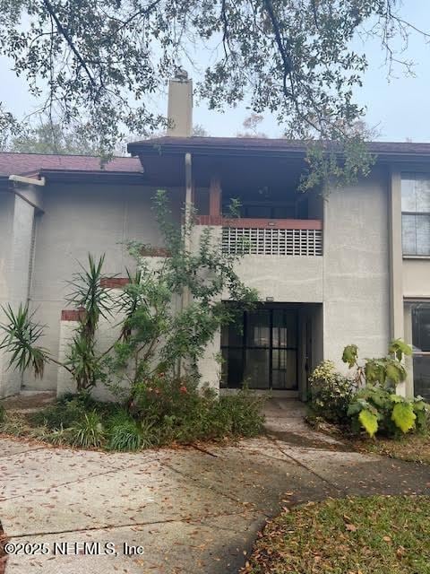 rear view of property with a balcony