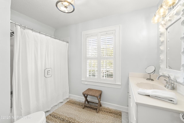 bathroom with vanity, toilet, a shower with shower curtain, and a textured ceiling